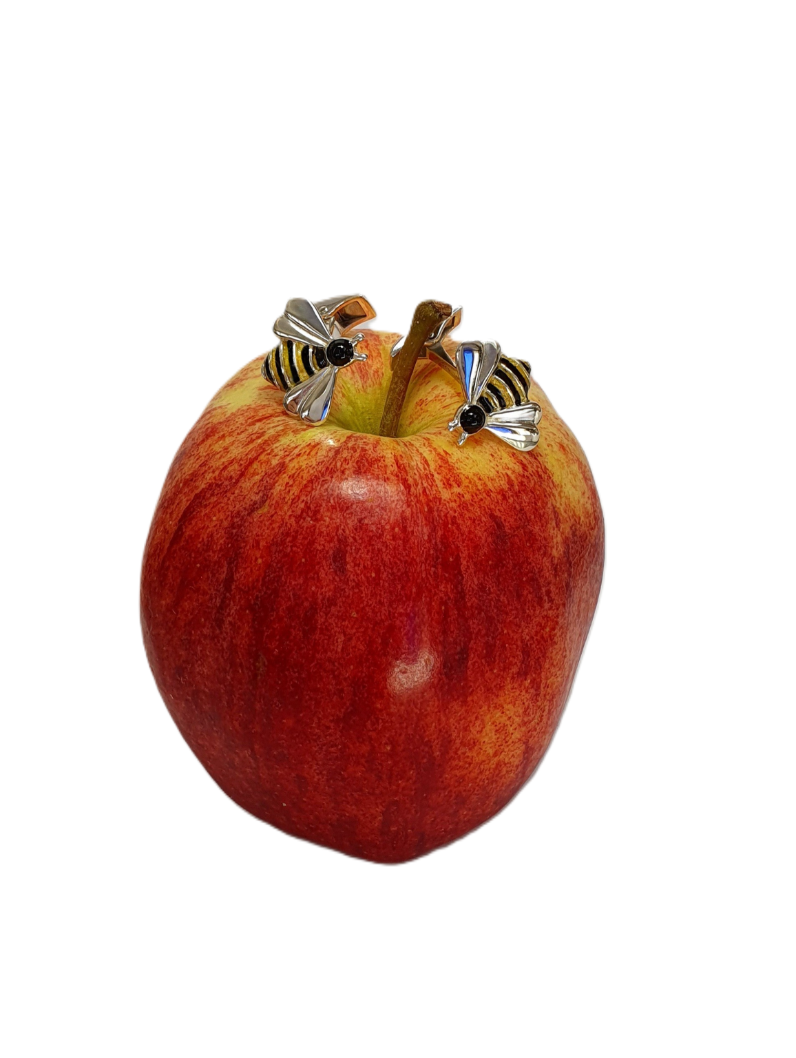 Handcrafted cufflinks resting on a fresh apple – A nature-inspired contrast highlighting the vibrant enamel detailing.