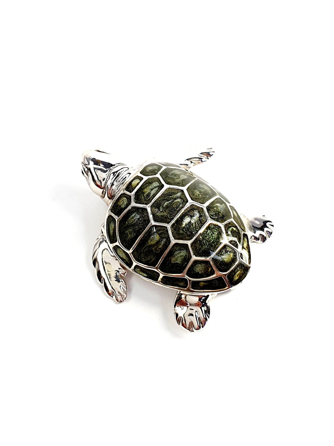 Top down view of the sterling silver enamelled turtle brooch against a neutral white background, highlighting its lustrous shell and intricate craftsmanship..