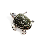 Top down view of the sterling silver enamelled turtle brooch against a neutral white background, highlighting its lustrous shell and intricate craftsmanship..