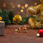 Genuine Silver teddy bear cufflinks covered with brown enamel CK00332, pictured with a Christmas scene background.