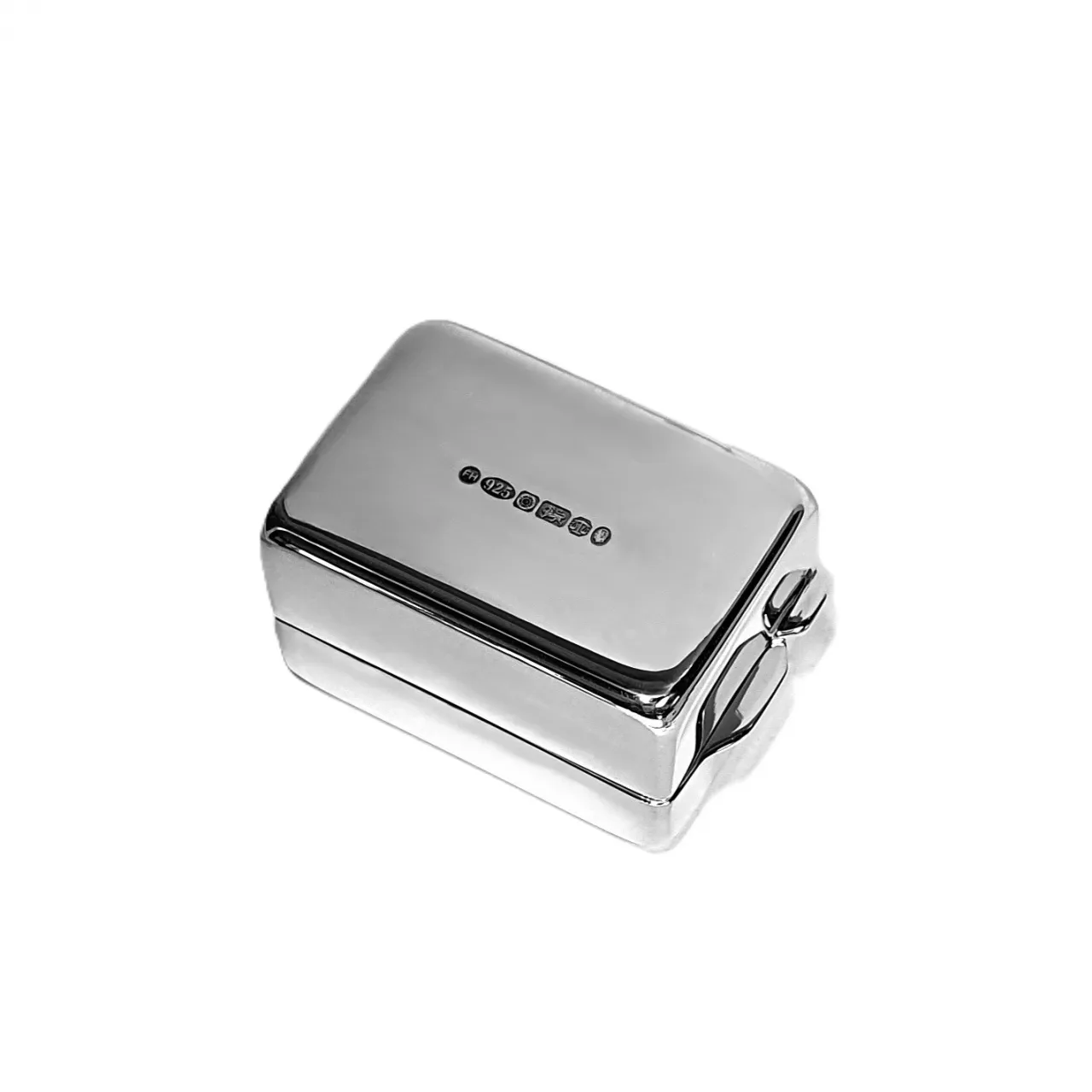 Close-up of silver pill container base showing UK hallmark stamp, highlighting authenticity and craftsmanship in detailed focus.