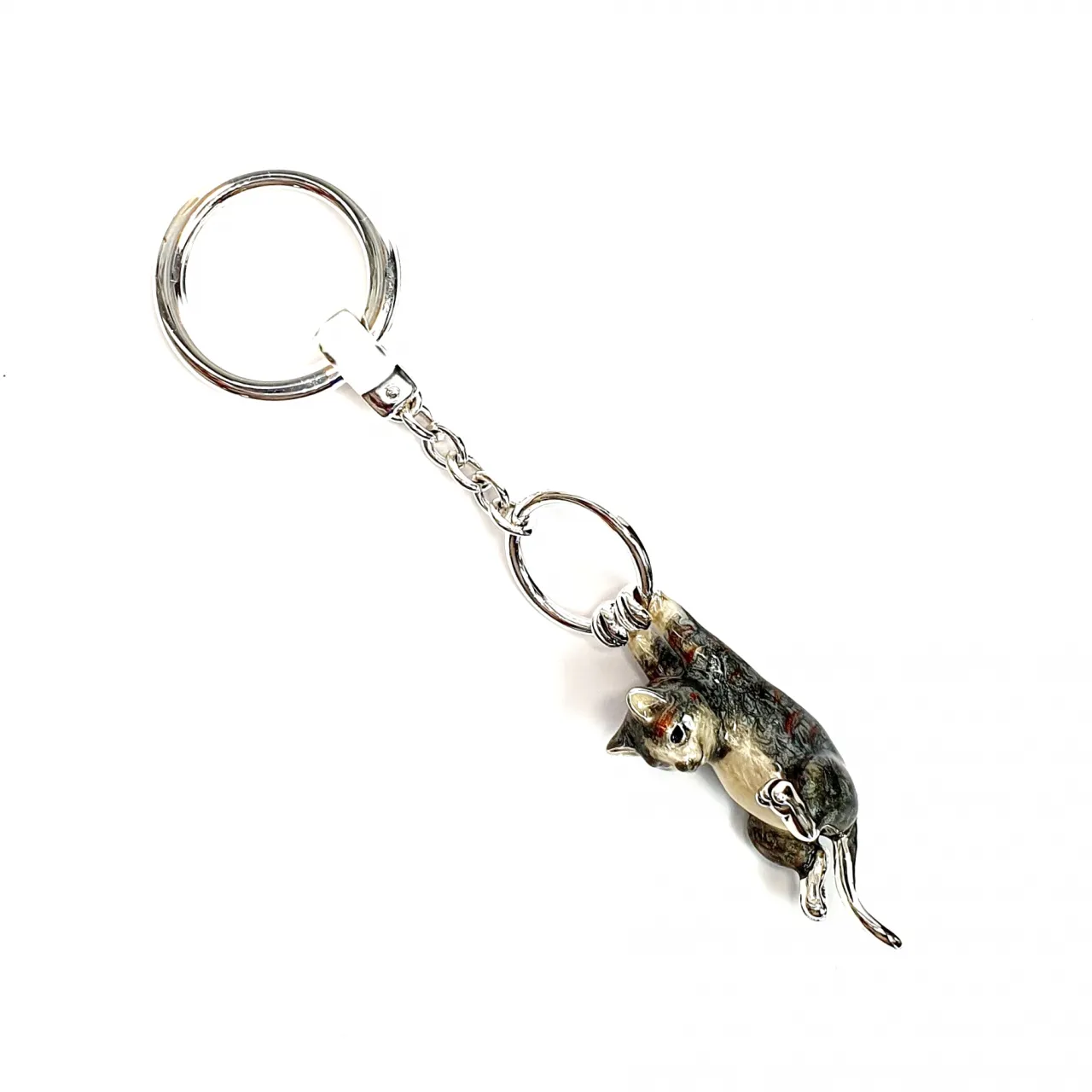 This Saturno handcrafted enamel keyring captures the playful personality of a grey brown tabby cat, hanging whimsically from the ring order number KF00048.Pictured from the side.