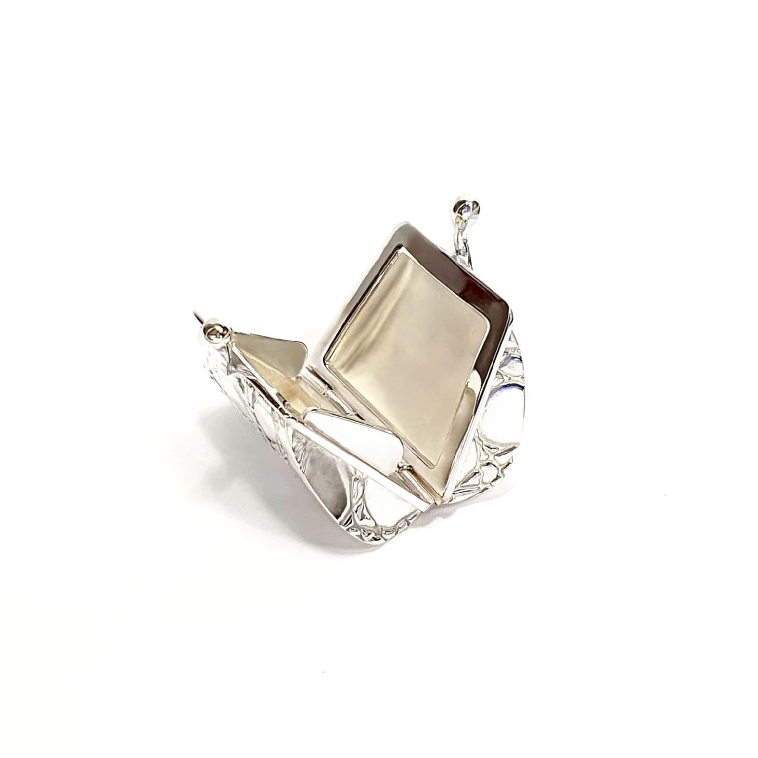 Sterling silver pill box opened, showing interior craftsmanship and hinge detail