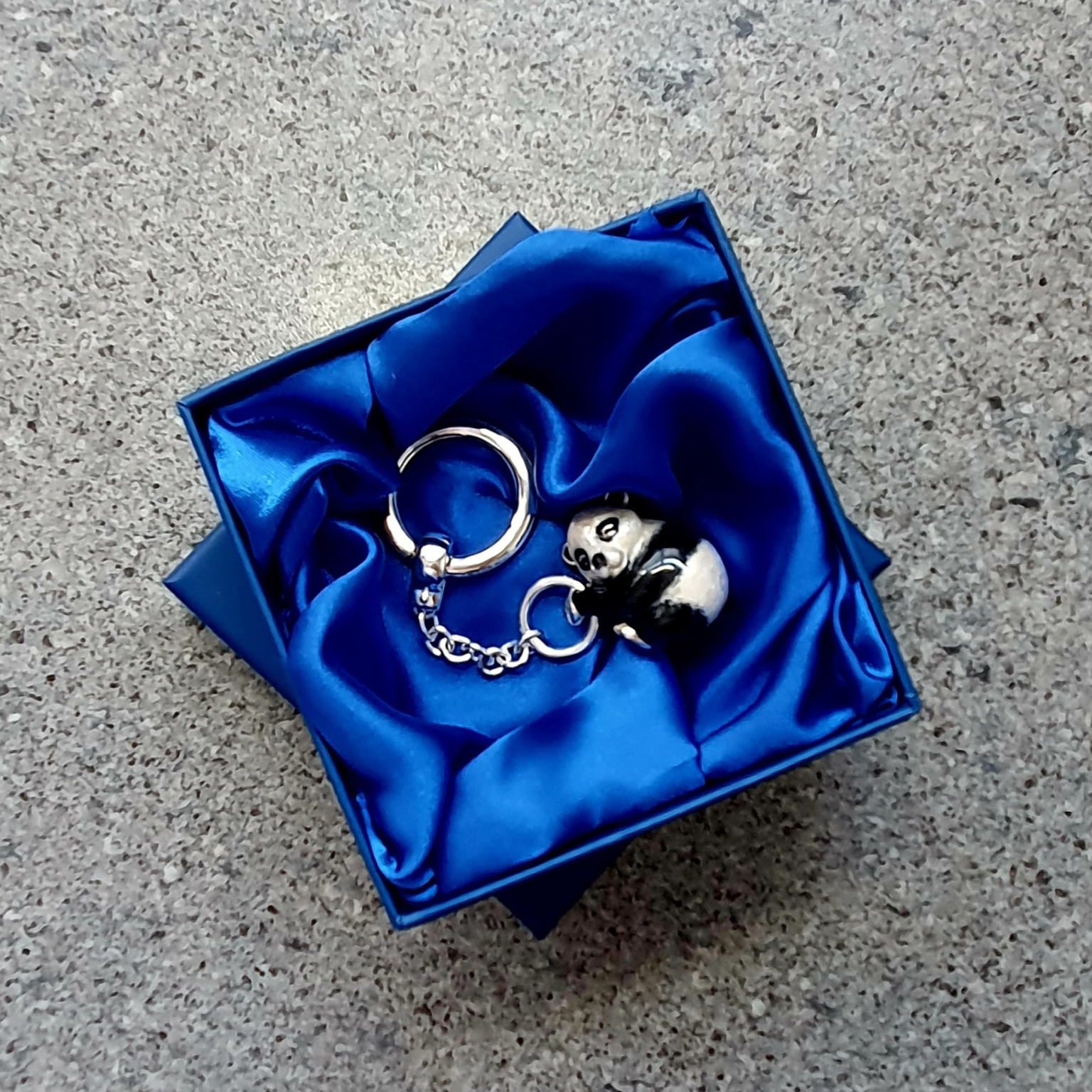 Real silver Panda bear key ring fob with black & white vitreous enamel pictured lying in the gift box.