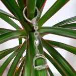 Hallmarked stirrup key fob with a highly polished finish. Pictured hanging from a plant for contrast.
