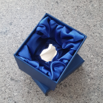 Silver pill box nestled inside silk-lined blue presentation box Luxuriously styled packaging highlights the craftsmanship and elegance of the piece as a premium gift item.