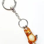 Hallmarked 925 silver ginger cat key fob or handbag charm with ginger and white enamel swinging from a ring.