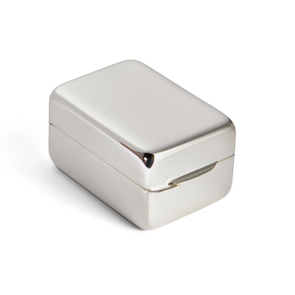 Closed tablet-shaped silver pill box resting on clean white background, emphasizing polished finish and classic geometry.