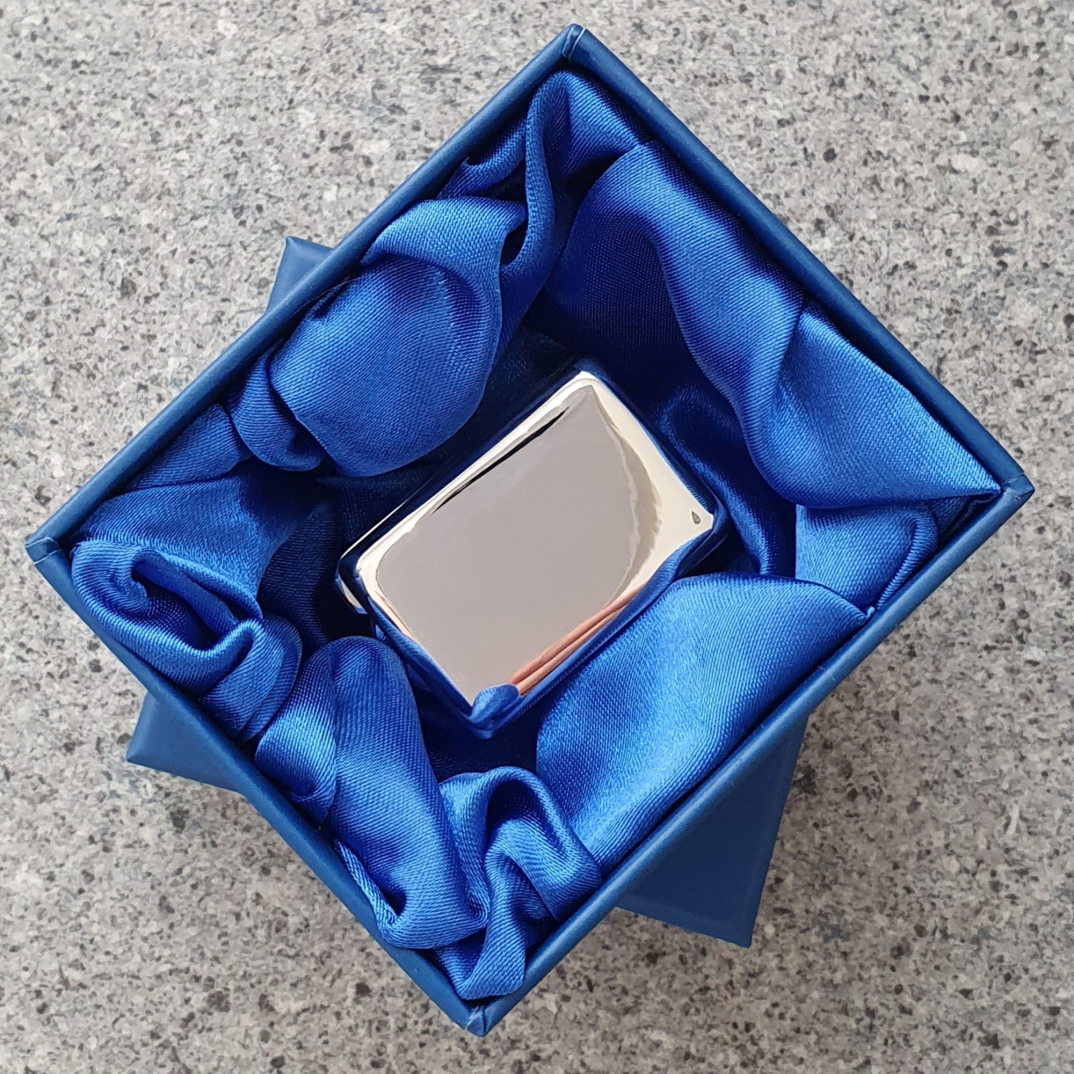 Sterling silver pill box in blue silk-lined gift box, displayed open to highlight elegant presentation packaging.