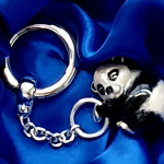 Real silver Panda bear key ring fob with black & white vitreous enamel pictured lying in the gift box.