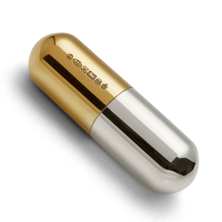 Sentimental & Thoughtful A capsule-shaped sterling silver and gold-plated pill box, presented in a silk-lined box—ideal for tiny essentials, memories, or a private remembrance.