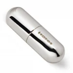 A compact silver pill box in capsule form was photographed against a soft white background, showing the hallmark.