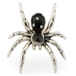 Close-up of a sterling silver spider cufflink with black enamel and white spots, photographed against a clean white backdrop.
