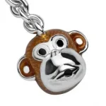 Close-up photograph of a Hallmarked sterling silver enamelled monkey head keychain by a renowned British silversmith, Deakin& Frances.