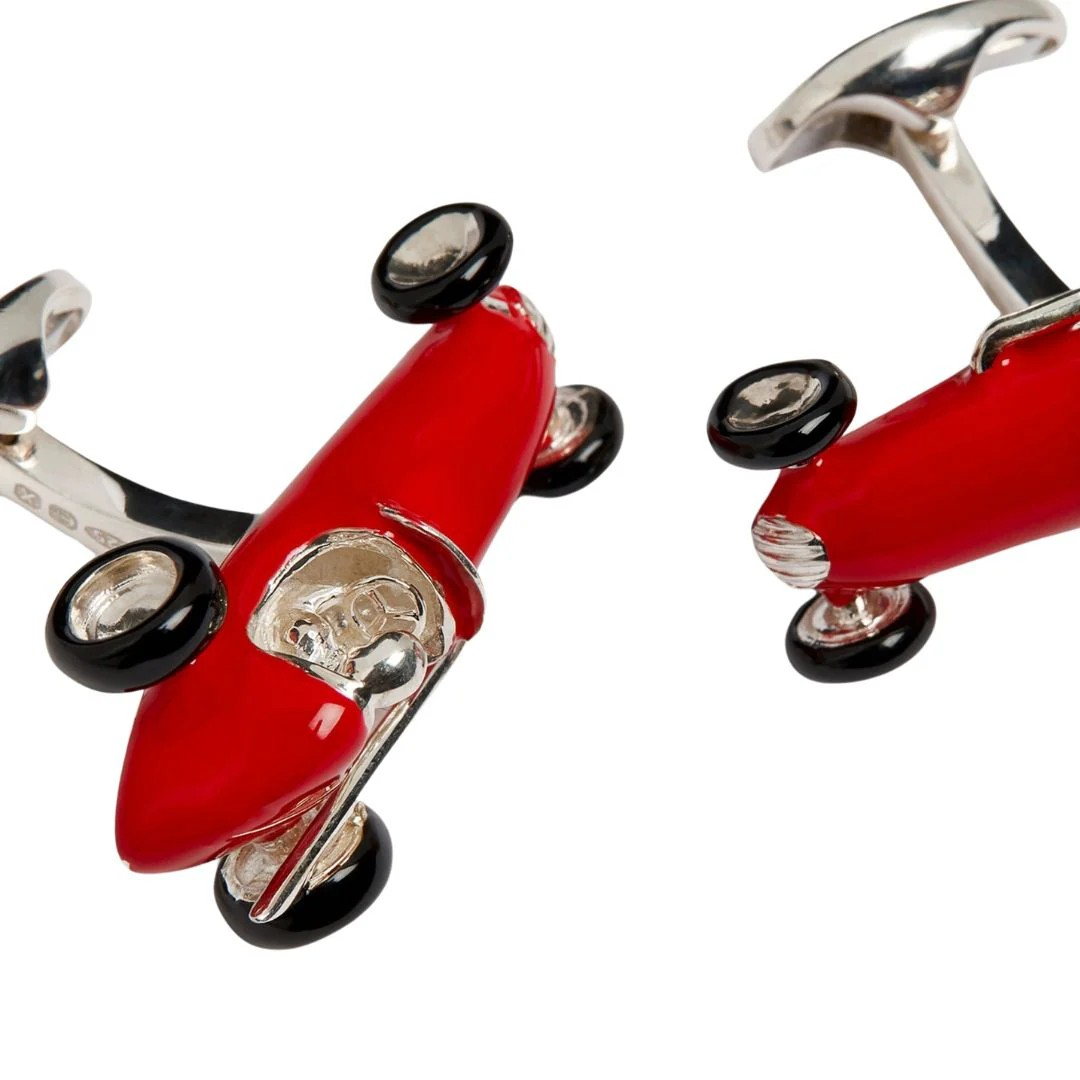 Side view of red enamel racing car cufflinks with black enamel tyres, inspired by vintage Grand Prix design.