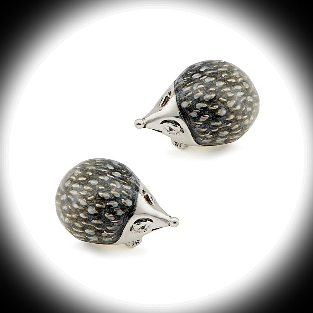 Sterling silver and enamel hedgehog cufflinks by Saturno displayed on a white background with a dark circular frame, emphasizing contrast and design detail.