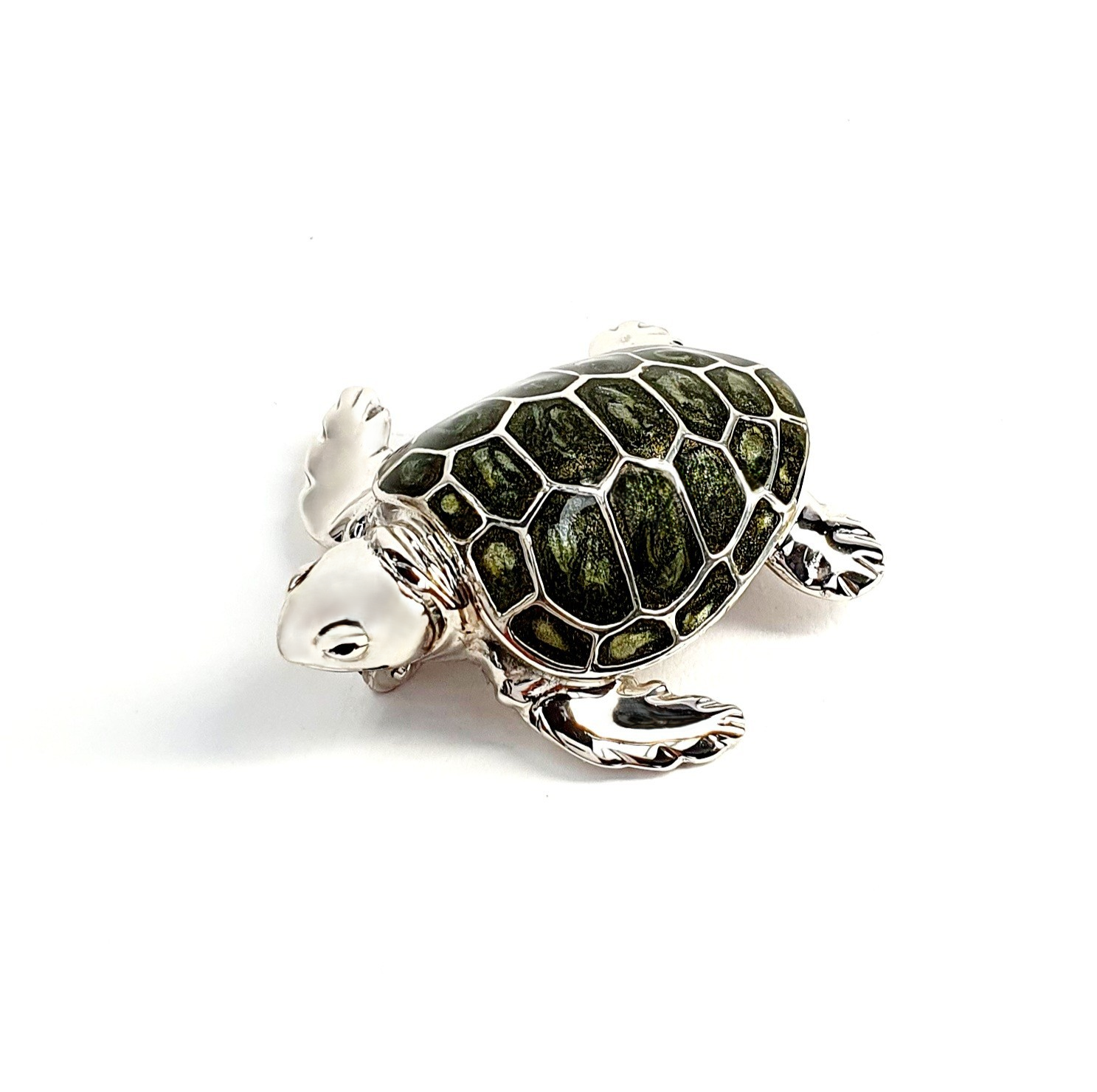 Angle view of the sterling silver enamelled turtle brooch against a neutral white background, highlighting its lustrous shell and intricate craftsmanship..