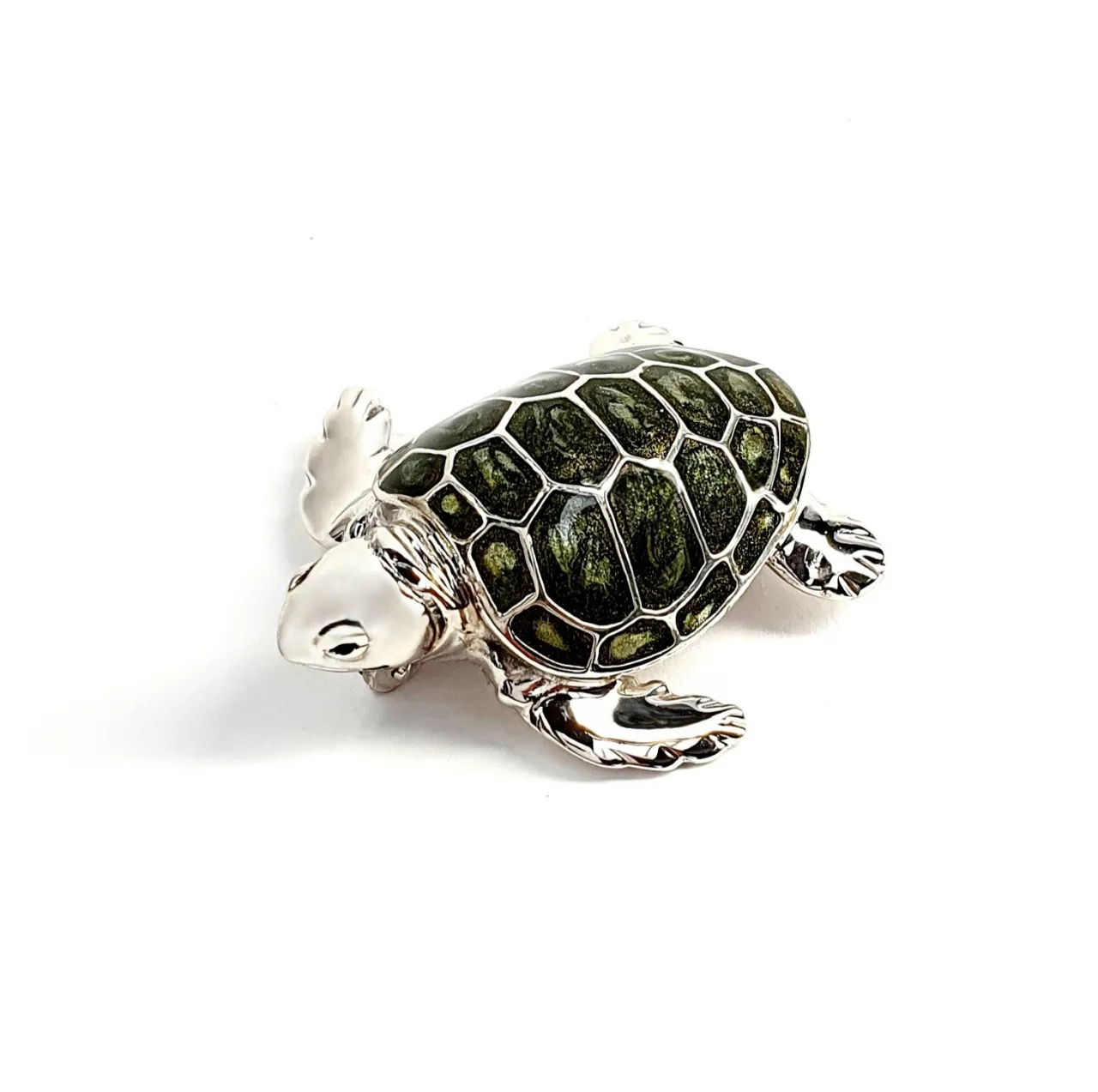 Angle view of the sterling silver enamelled turtle brooch against a neutral white background, highlighting its lustrous shell and intricate craftsmanship..