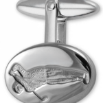 Detailed close-up of golfer engraving on sterling silver cufflink, showcasing fine texture, artisanal finish, and subtle shine.