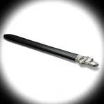 “Sterling Silver Dog Head Letter Opener under a warm spotlight, casting gentle shadows across the detailed silver dog’s head and glossy acrylic blade.”