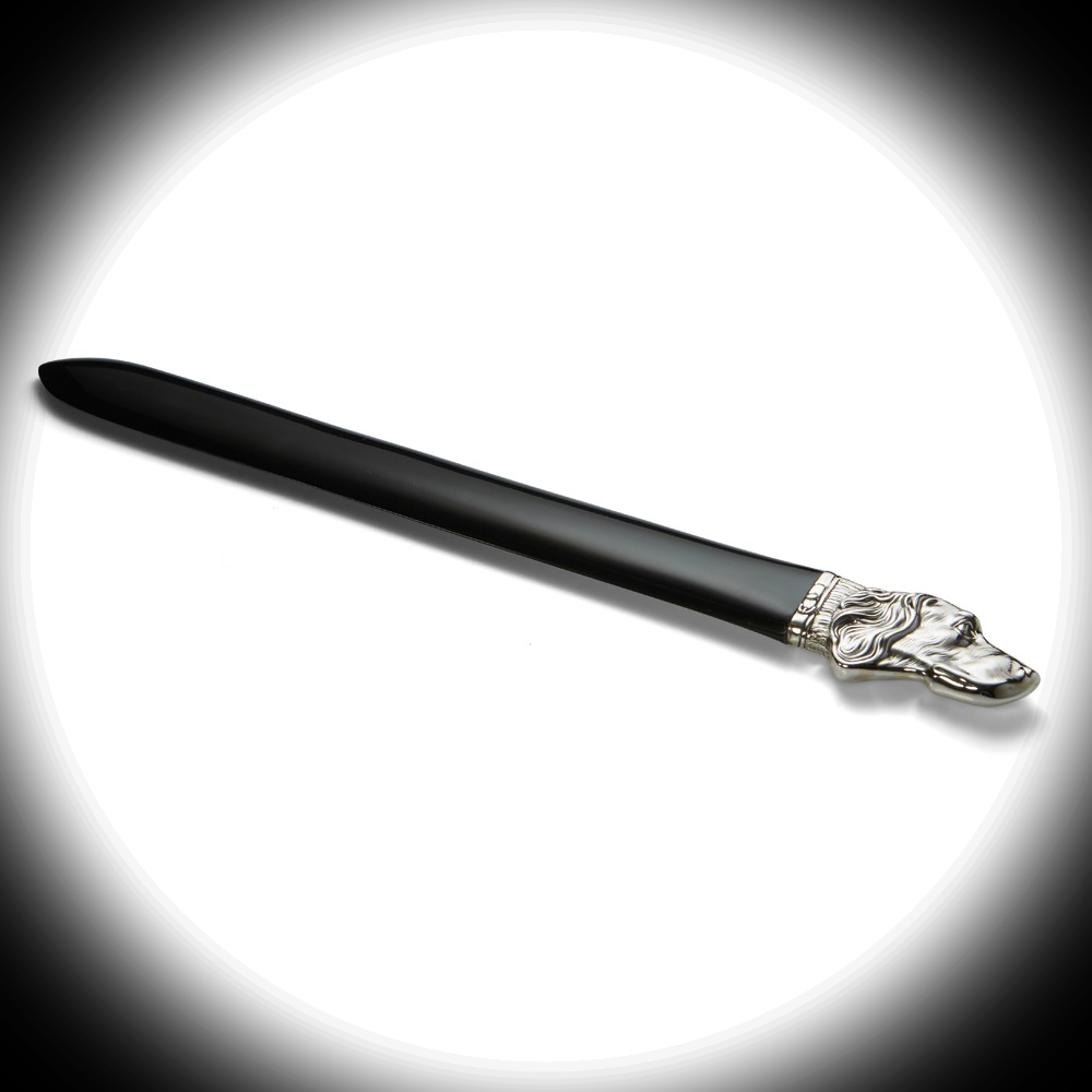 “Sterling Silver Dog Head Letter Opener under a warm spotlight, casting gentle shadows across the detailed silver dog’s head and glossy acrylic blade.”