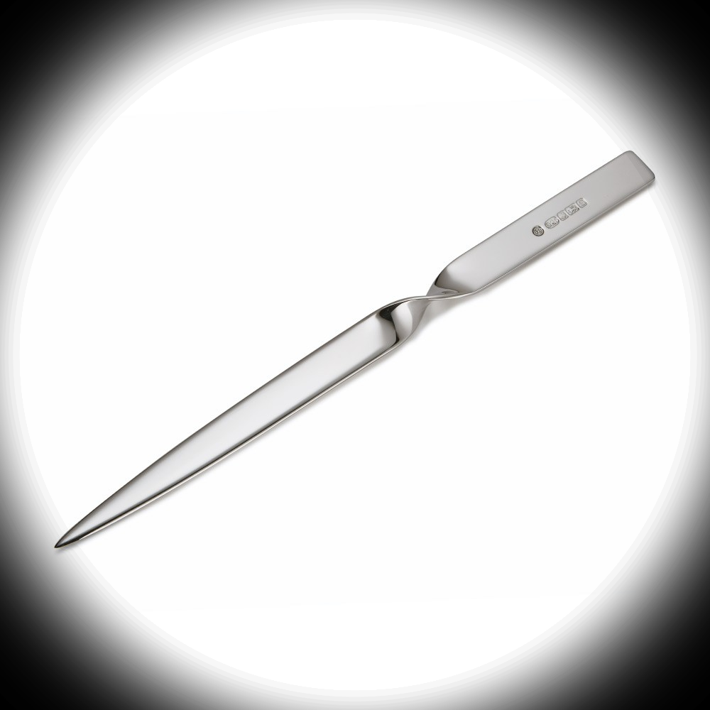 Sterling Silver Letter Opener illuminated by white spotlight against black backdrop, showing elegant twist and hallmark detail on the handle.