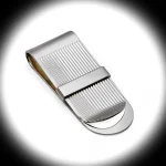 "Dramatic spotlight on the Stripe Money Clip with polished band across stripes, highlighting its engraving-ready surface and silver craftsmanship."
