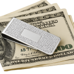 Sterling Silver Barling Barley Money Clip resting on folded US dollar bills, A1 angle highlights barley pattern and central cartouche, symbolising luxury and practicality.
