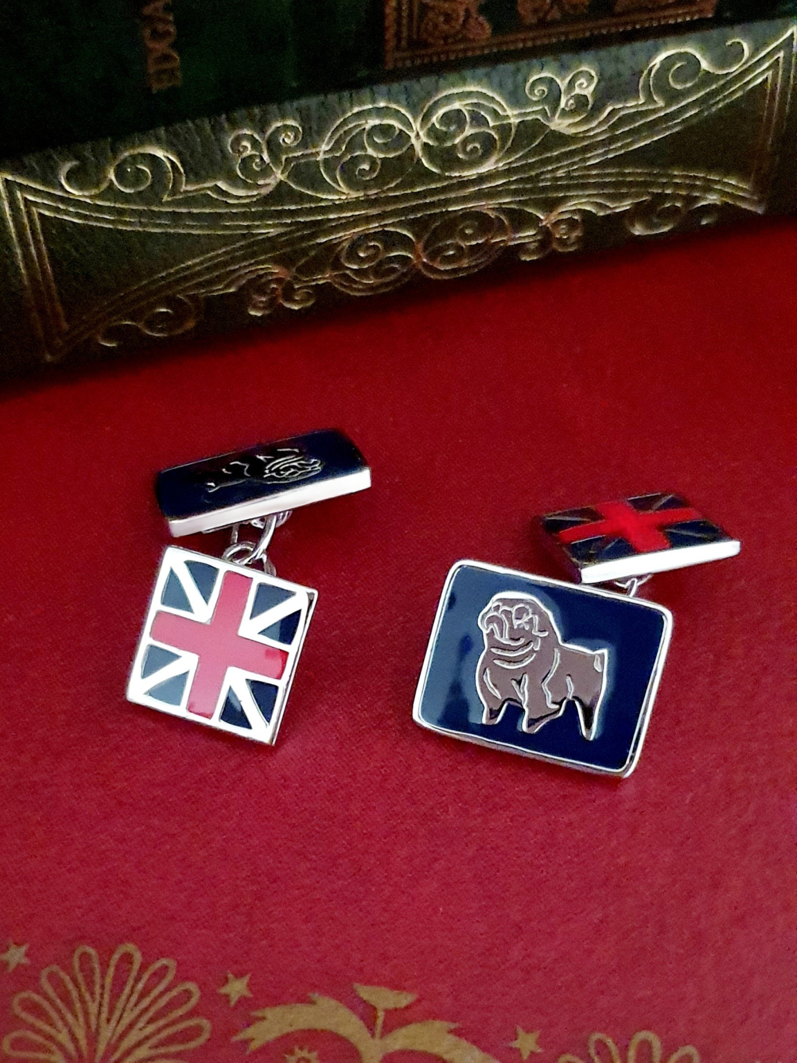 Sterling silver cufflink shown from a front angle, highlighting enamel detail and polished finish.