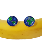 Map of the world cufflinks resting on a banana, showcasing playful styling and contrast with yellow tones
