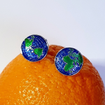 The Weldon cufflinks resting on an orange, highlighting colour contrast and playful styling