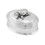 Polished oval silver box with hinged lid, scroll border, and movable turtle on top. Shown on a plain white background.