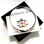 Dual-purpose luxury sterling silver desktop domed paperweight magnifying glass showing the ten times magnification on top of a business card