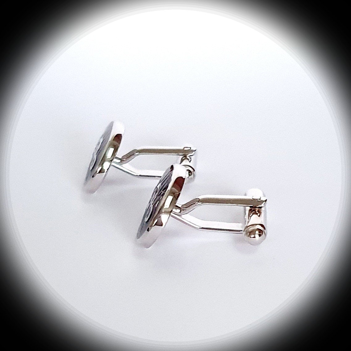 Side profile of Sterling Silver Treble Clef cufflink under spotlight, revealing thickness and craftsmanship
