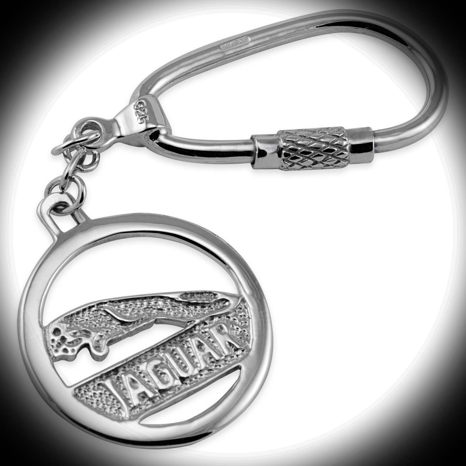 Sterling Silver Jaguar Keyring KF00062 in dramatic spotlight with a soft dark vignette, highlighting its sculptural form and luxury craftsmanship.