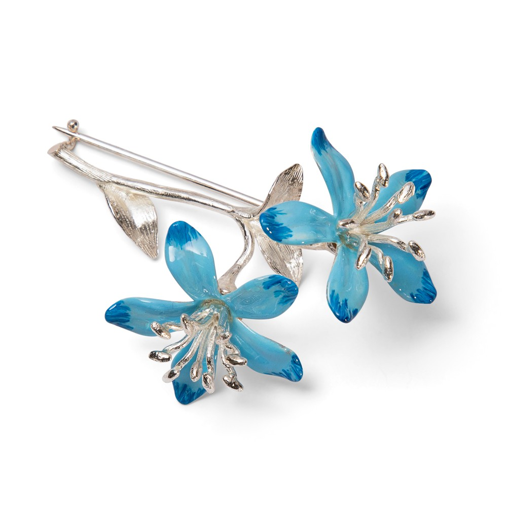Sterling silver blue enamel blossom brooch facing right, showing two‑tone high‑gloss blue petals and silver‑toned stamens on a white background.