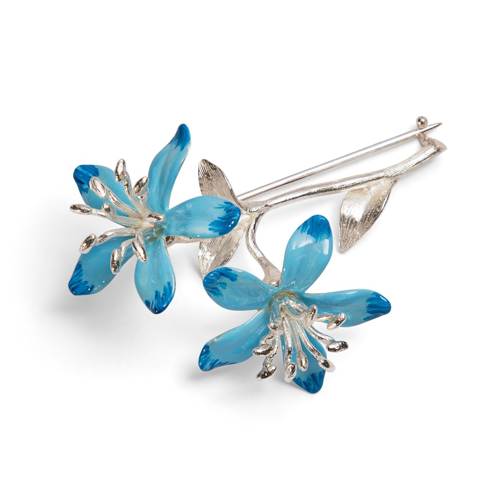 Sterling silver blue enamel blossom brooch facing left, with two‑tone high‑gloss blue petals and silver‑toned stamens on a white background.