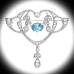 Sterling Silver Art Nouveau Style Brooch with blue and white stones displayed against a black surround with a white spotlight highlighting the centre of the brooch.