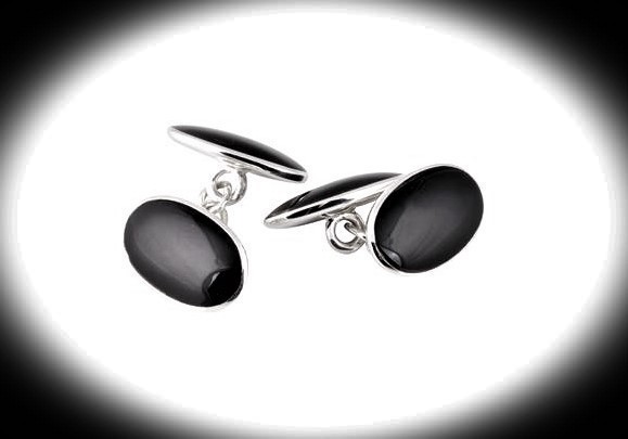 Black onyx oval cufflinks on a black background with a spotlight effect