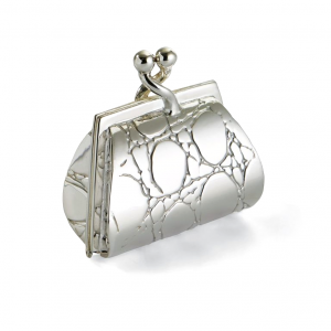 Sterling silver handbag-shaped pill box closed, photographed against a plain white background to highlight its polished detail.