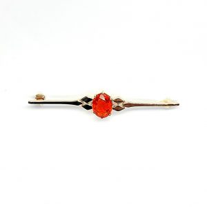 A handmade 9ct yellow gold bar brooch 52mm long set with a gorgeous top quality oval fire opal measuring 8.6mm x 7mm portrait set to the middle of the bar with three 9ct gold diamond shapes to each side of the stone with a straight pin to the back with a swivel safety catch.