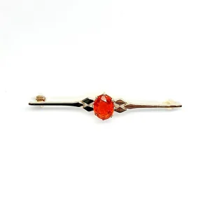 A handmade 9ct yellow gold bar brooch 52mm long set with a gorgeous top quality oval fire opal measuring 8.6mm x 7mm portrait set to the middle of the bar with three 9ct gold diamond shapes to each side of the stone with a straight pin to the back with a swivel safety catch.
