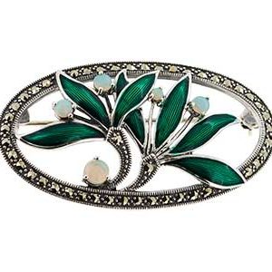 Front view of a sterling silver brooch featuring green enamel leaves, real opal berry accents, and a marcasite‑studded oval surround, displayed on a white background