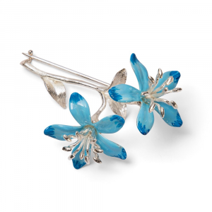 Sterling silver blue enamel blossom brooch facing right, showing two‑tone high‑gloss blue petals and silver‑toned stamens on a white background.