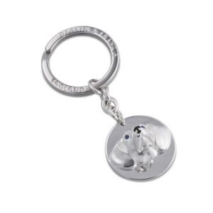 Genuine 925 silver key ring with the face of a Dachshund dog with blue sapphire eyes. Facing the front.