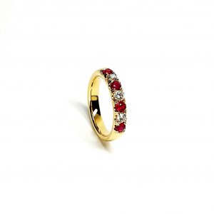 18ct yellow gold ruby and diamond half eternity ring set with three round white diamonds and four round blood red rubies, a solid tactile ring with rounded edges