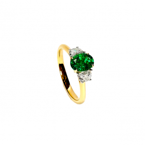 18ct yellow and white gold three stone ring with one oval emerald in the centre and two half moon diamonds, one on each side RA00700.