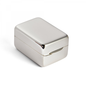 Closed tablet-shaped silver pill box resting on clean white background, emphasizing polished finish and classic geometry.
